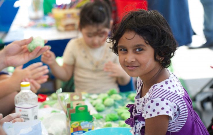 Young girl sits at a craft table