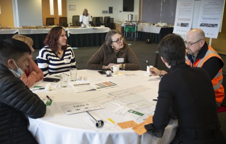 A group of people sitting around a table engaged in conversation