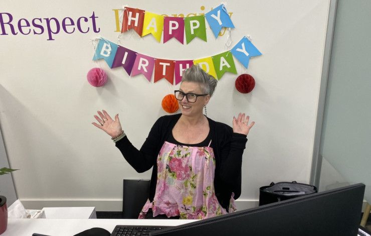 person in front of words happy birthday