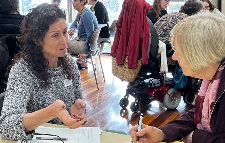 Two people sitting at a table talking