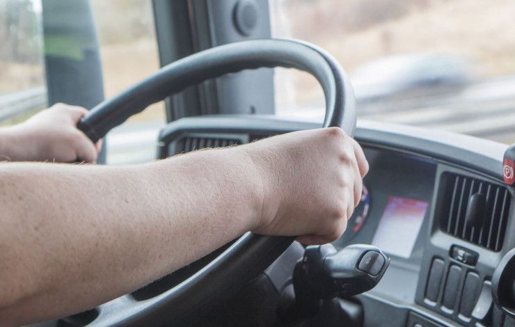 a person in the driver's seat of a truck