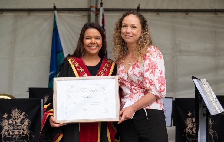 Mayor Eden Foster and Zoe Mohl holding a framed certificate