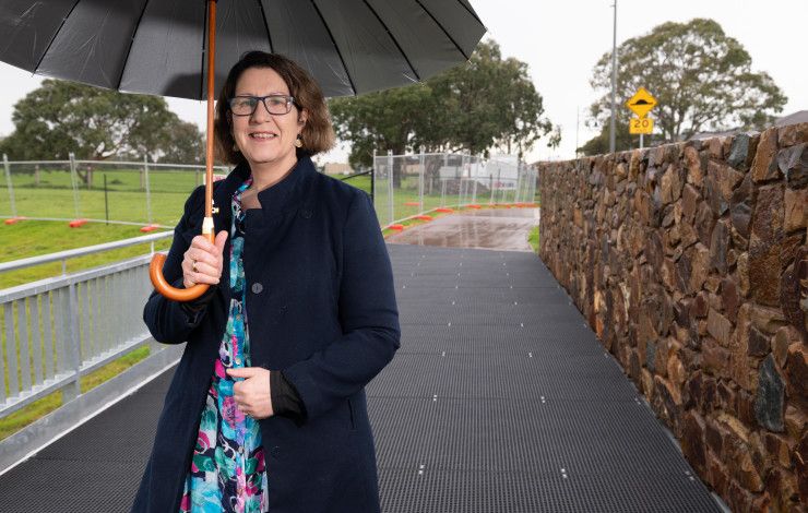 Councillor Rhonda Garad standing under an umbrella at the site of the future Keysborough South Hub