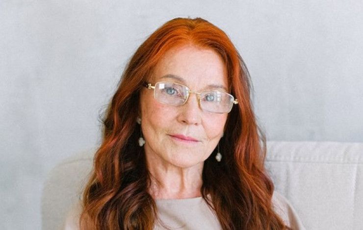 a person with orange hair smiling