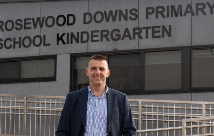 Councillor Bob Milkovic standing in front of the Rosewood Downs Primary School Kindergarten