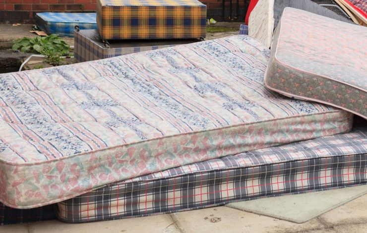a pile of used mattresses 