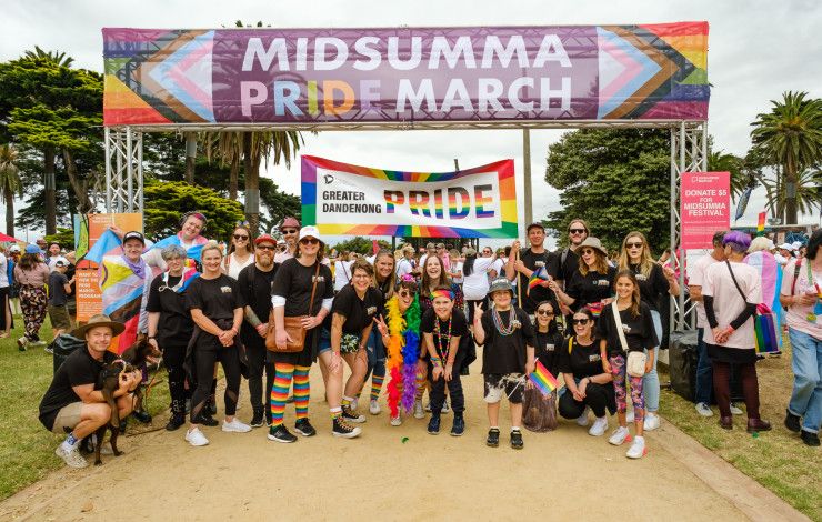 people under a midsumma banner