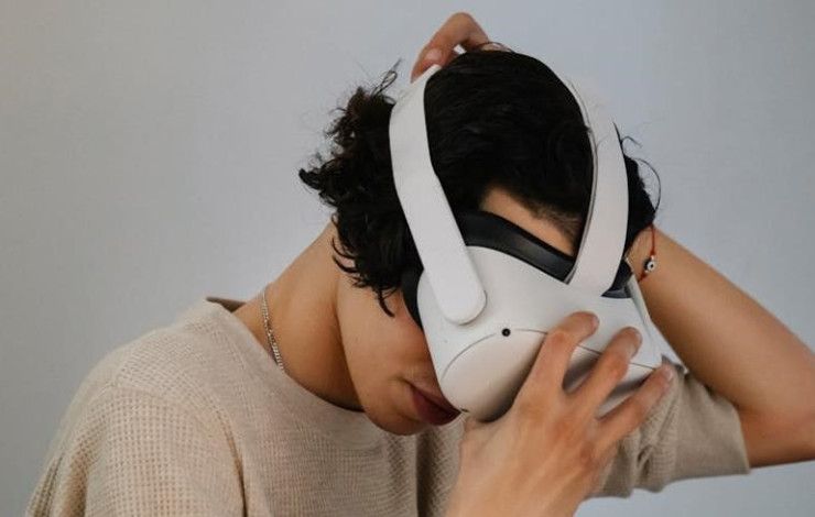 A person putting on a headset