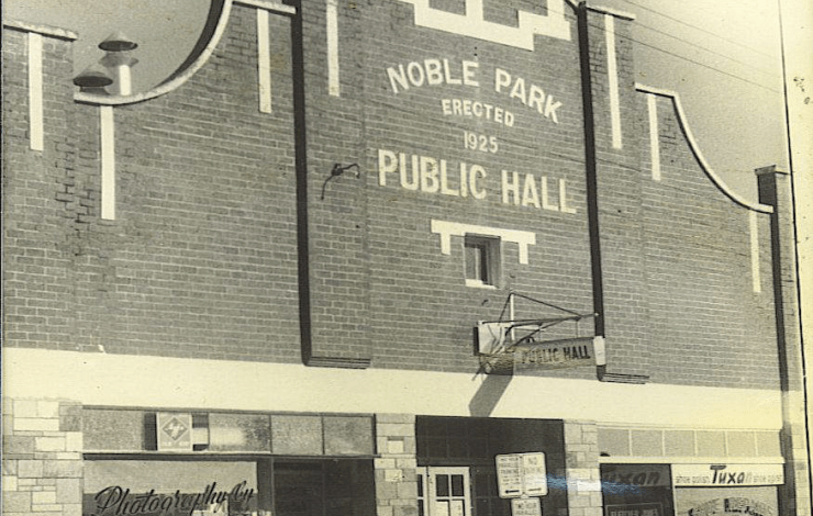 An ornate brick building with a sign reading Noble Park Public Hall erected 1825.