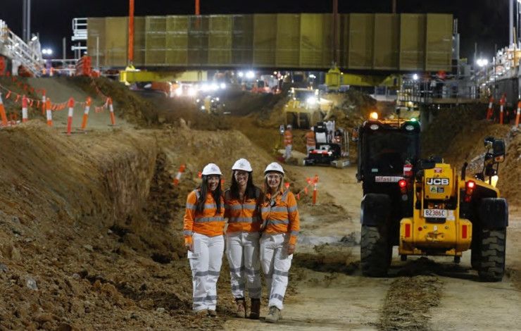 Three ladies standing in a construction site