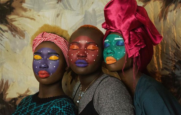 Three women with painted faces