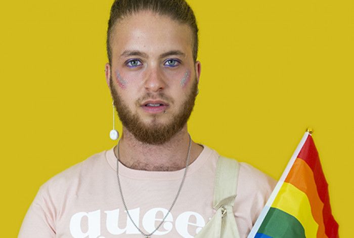 Man holding rainbow flag