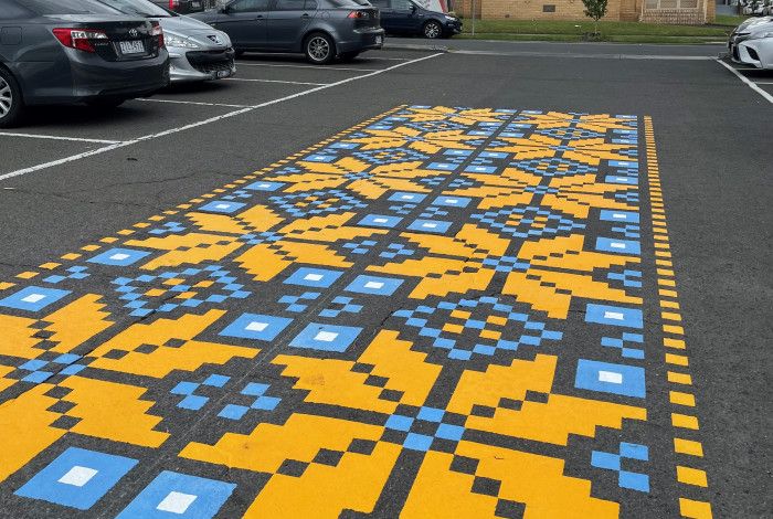 a blue and yellow mural on the road