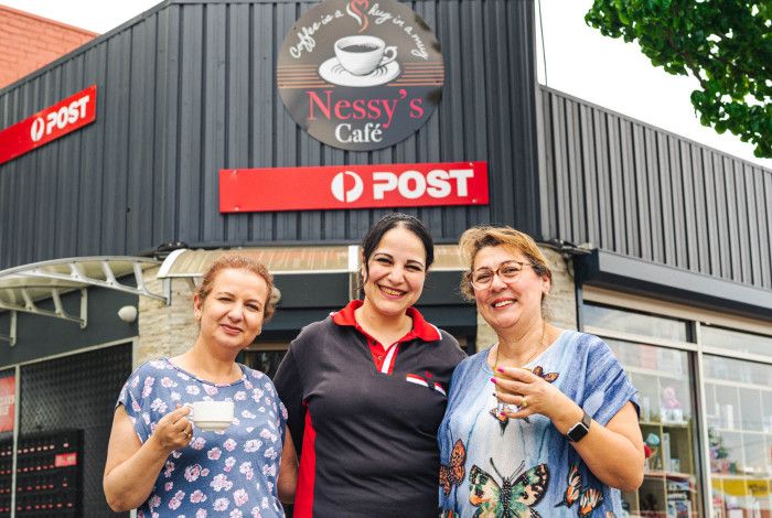 Three ladies standing in front of Nessys Cafe