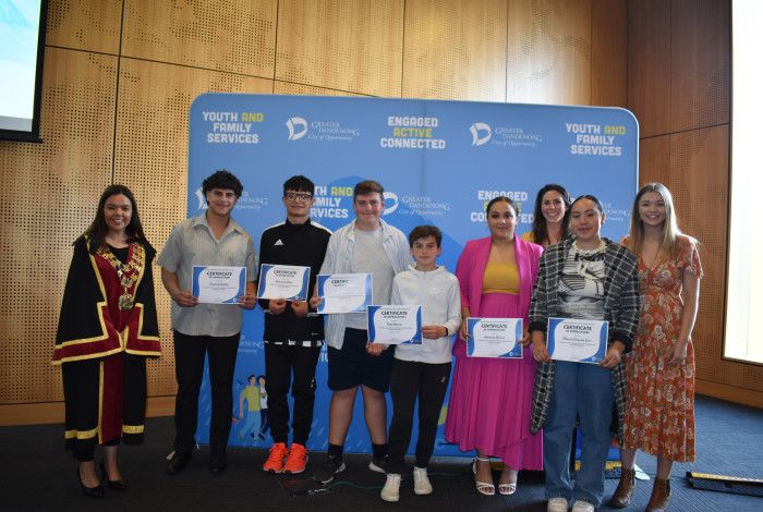 Mayor Eden Foster poses with a group of Young Leaders holding certificates