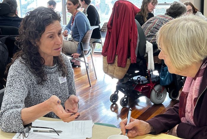 Two people sitting at a table talking