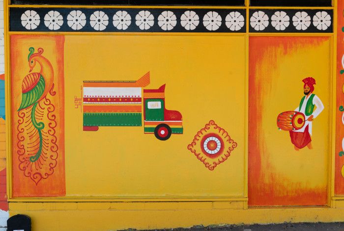 Painting on a wall of a truck and people