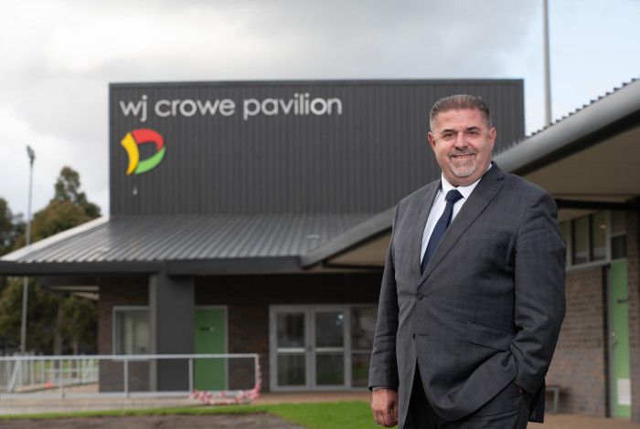 Jim Memeti in front of WJ Crow Paviliam building