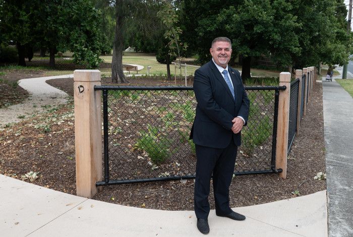 Cr Jim Memeti standing at a park