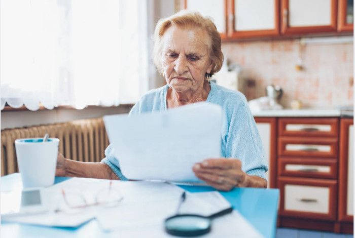 A lady looking at her bills