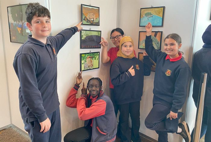 Children showing their artwork