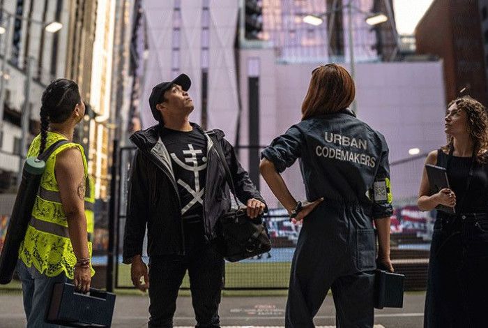 Four people standing and looking up