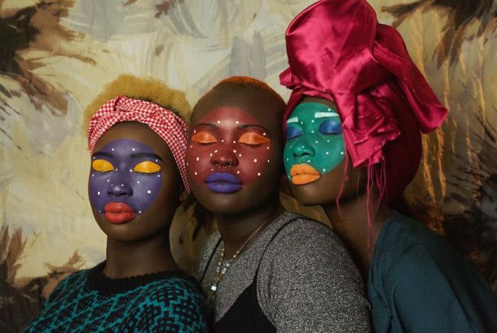 Three women with their faces painted