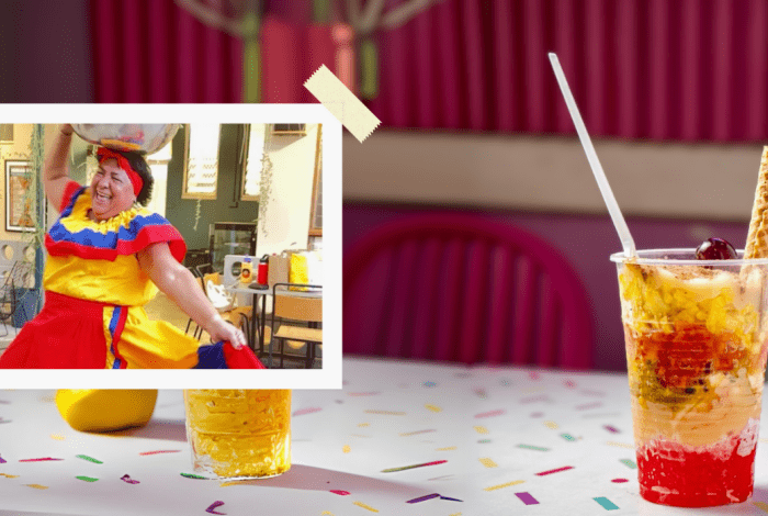 Colombian cup dessert presented on a table with a lady on the side dancing in colombian costume.