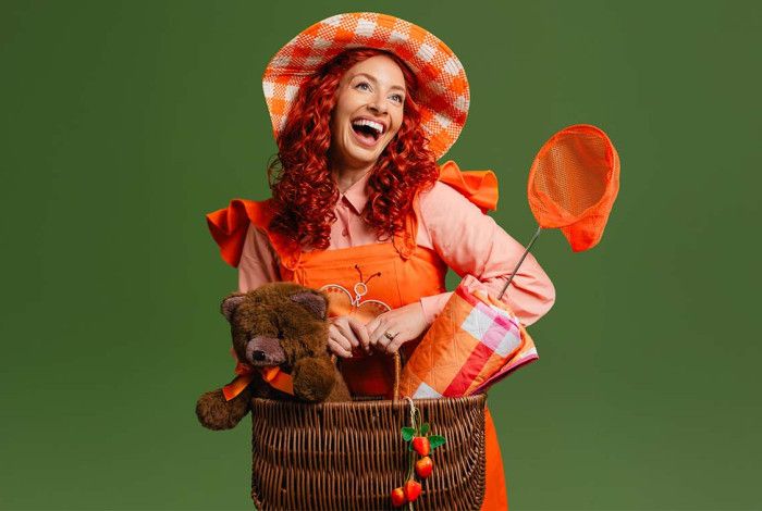 A lady holding a picnic basket