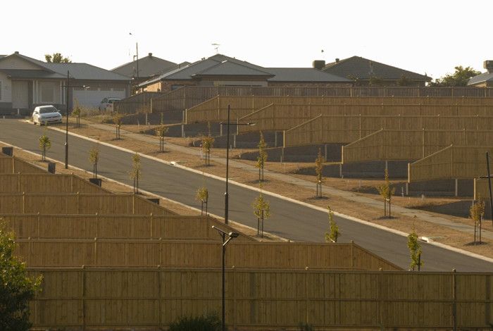 Photo of a car at the top of hill in an estate.