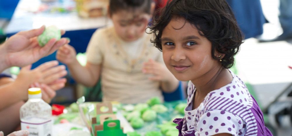 Young girl sits at a craft table