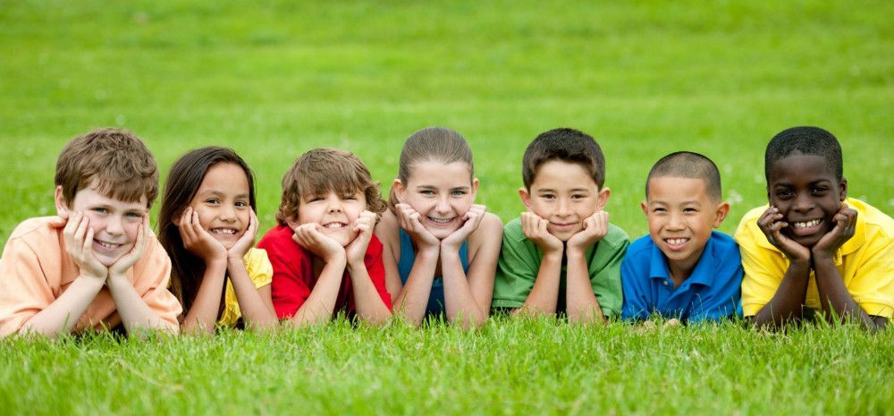 children laying on grass