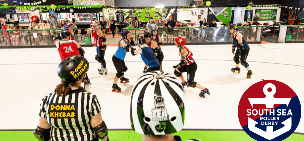 People in a skating rink on rollerskates