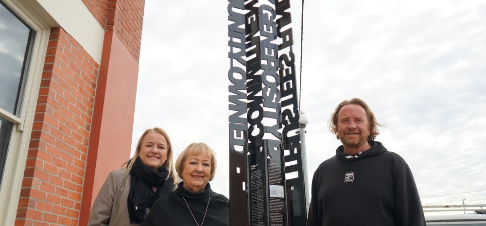 Family of Paddy O'Donoghue with the Noble Park Public Hall sign
