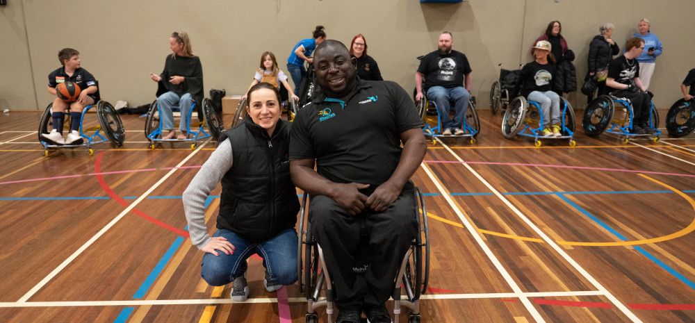 People on a basketball court in wheelchairs