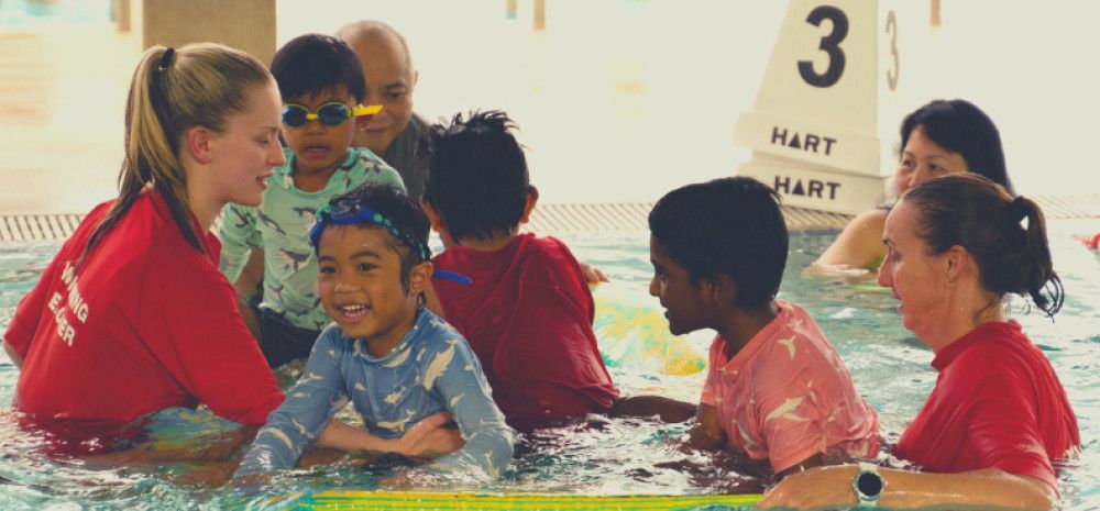 Children swimming with instructors