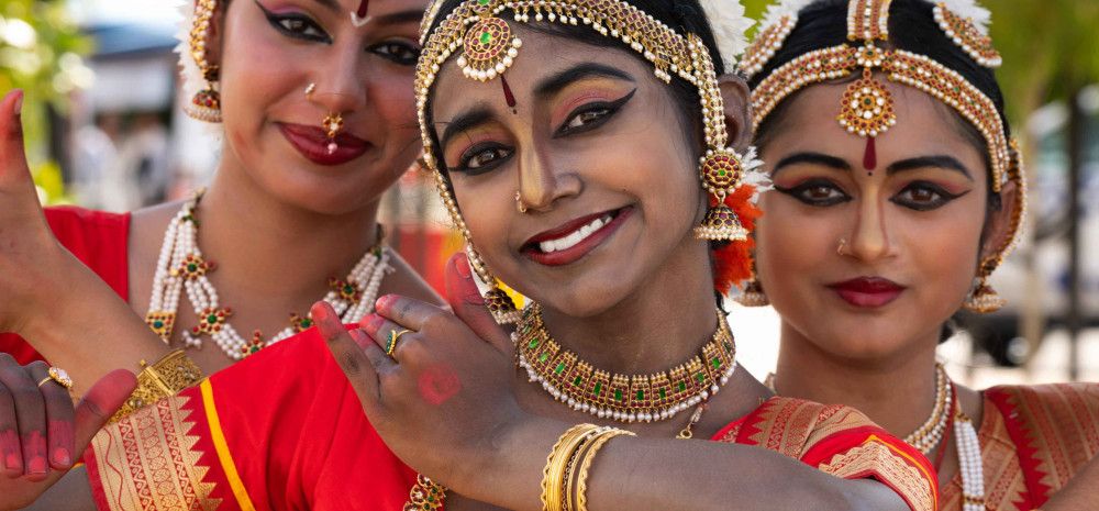Three Kuchipudi dancers in bright-coloured traditional dress