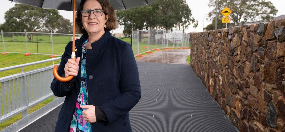 Councillor Rhonda Garad standing under an umbrella at the site of the future Keysborough South Hub