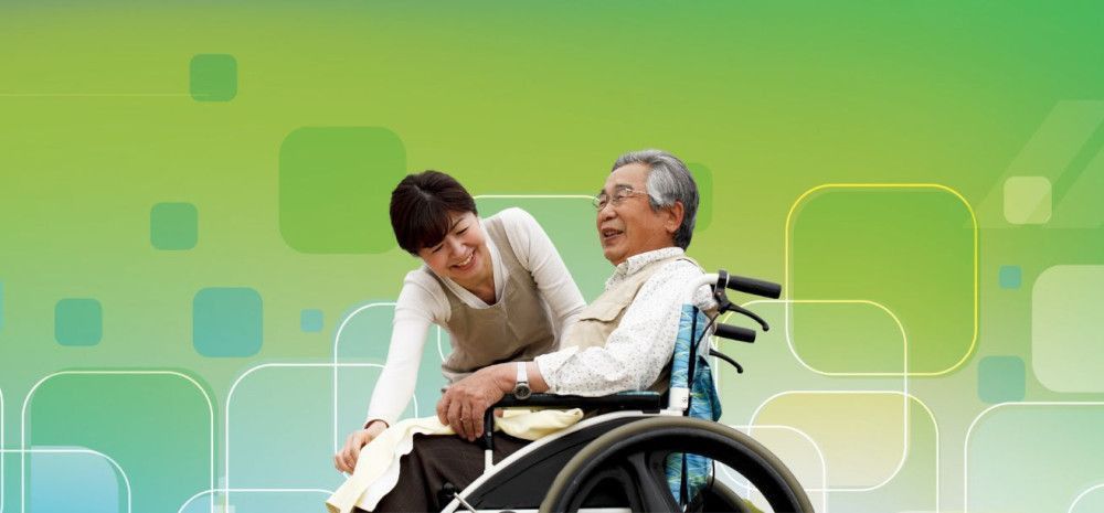 blue and green pattern background with person assisting man in wheelchair