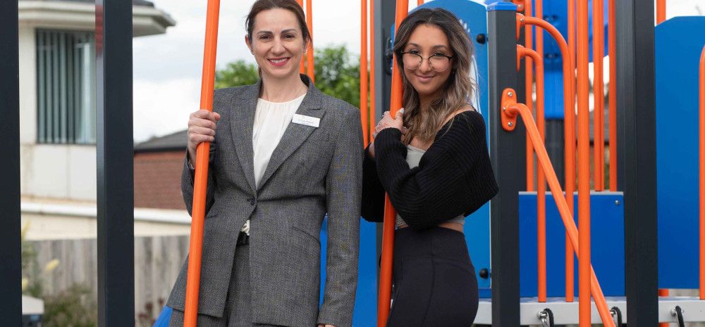 Councillor Lana Formoso with a young resident on play equipment.