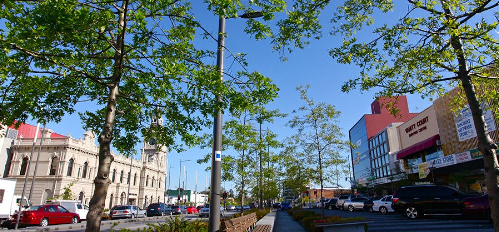 A street with cars and buildings in Dandenong