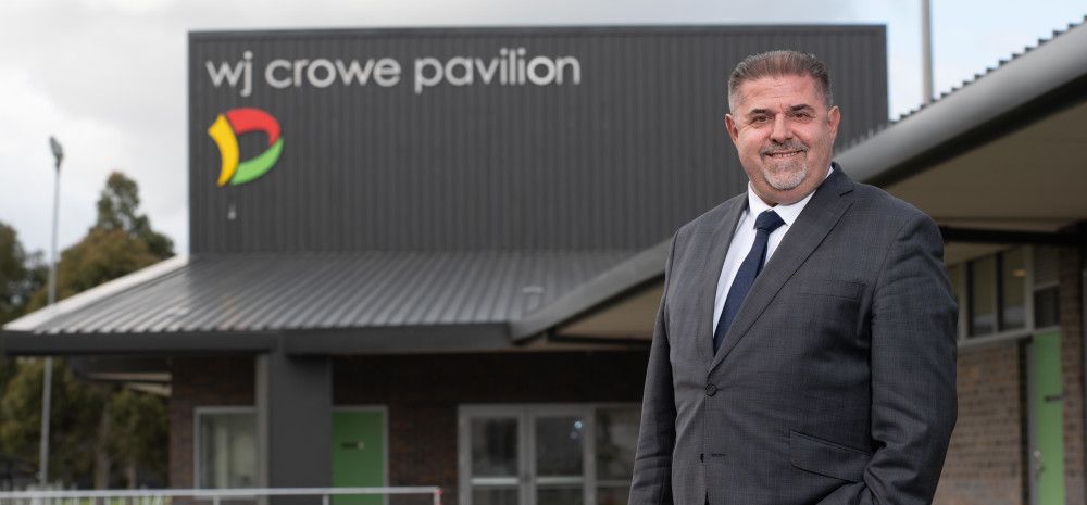 Jim Memeti in front of WJ Crow Paviliam building