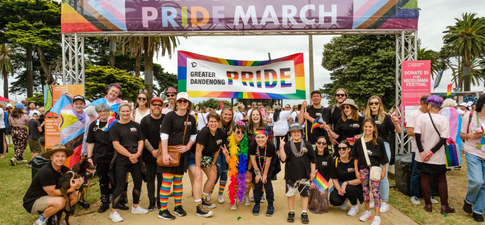 people under a midsumma banner