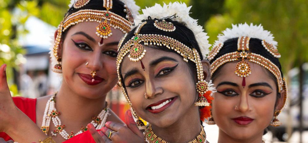 Three women dressed in cultural clothing