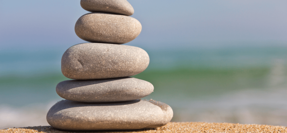 pebbles stacked on each other on a beach.