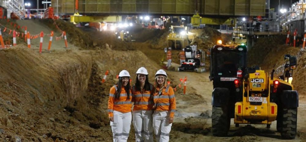 Three ladies standing in a construction site