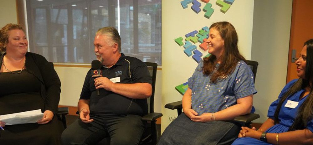 Four people sitting and talking