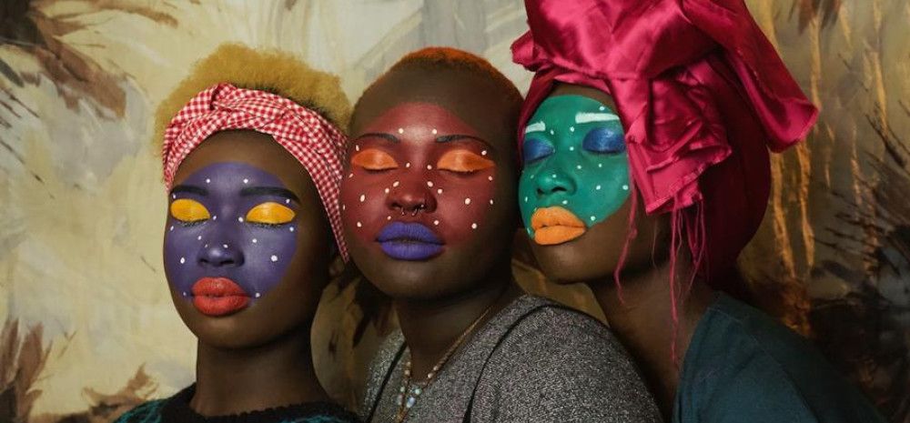 Three women with painted faces