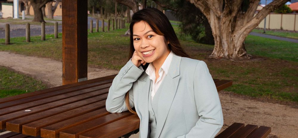 Councillor Melinda Yim sitting at a park bench