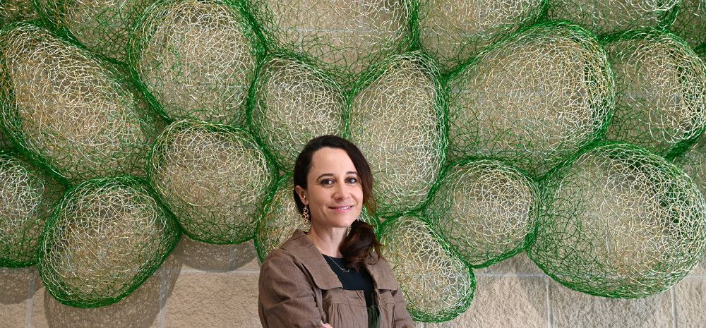 Artist standing in front of public art